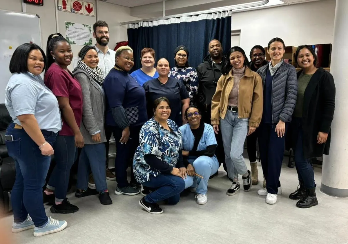 Site staff smiling, taking a group photo